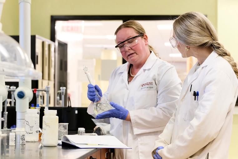 Dr, Christa  Brosseau in the lab with student