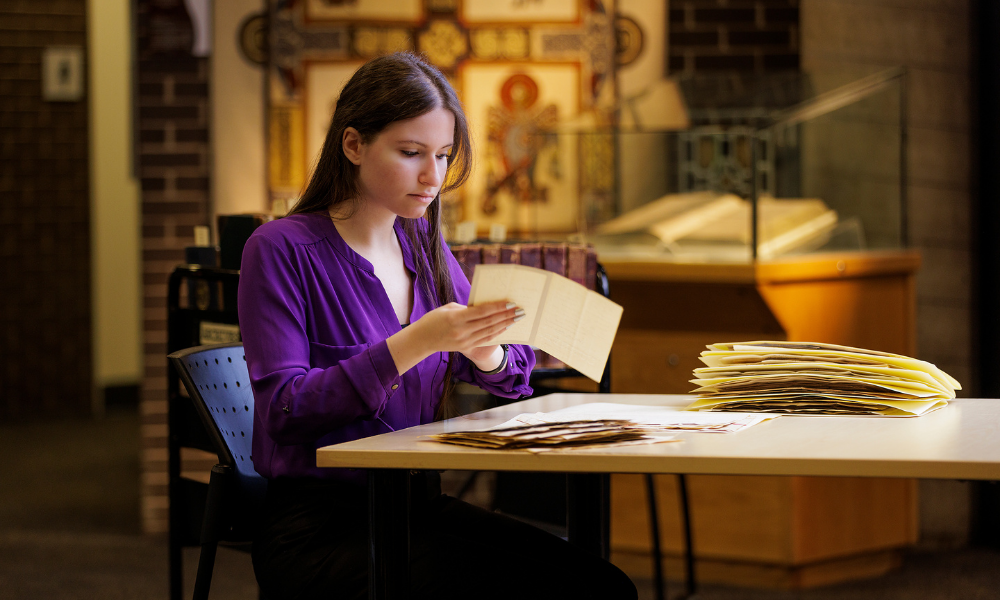 A student reads through old documents in the library