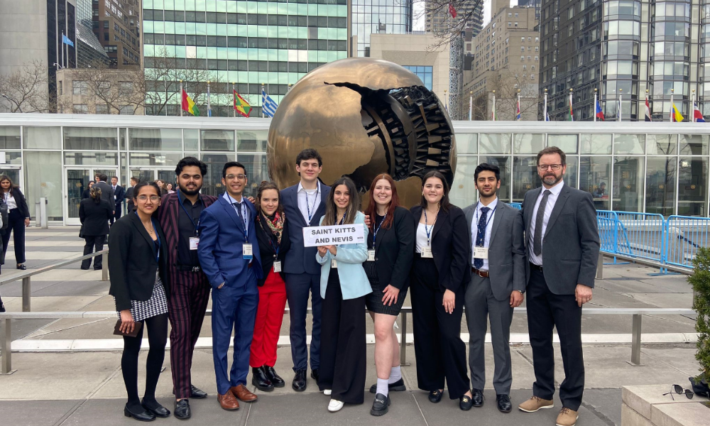 A group of students pose outside of the UN in New York
