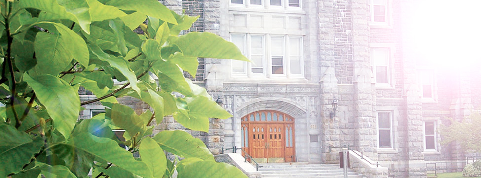 A bright sun shines on the entrance to the McNally Building