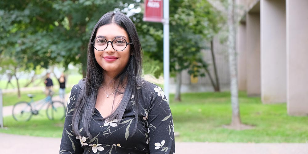 A young woman standing in the quad area.